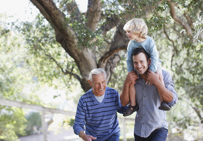 Three generations of men walking outdoors