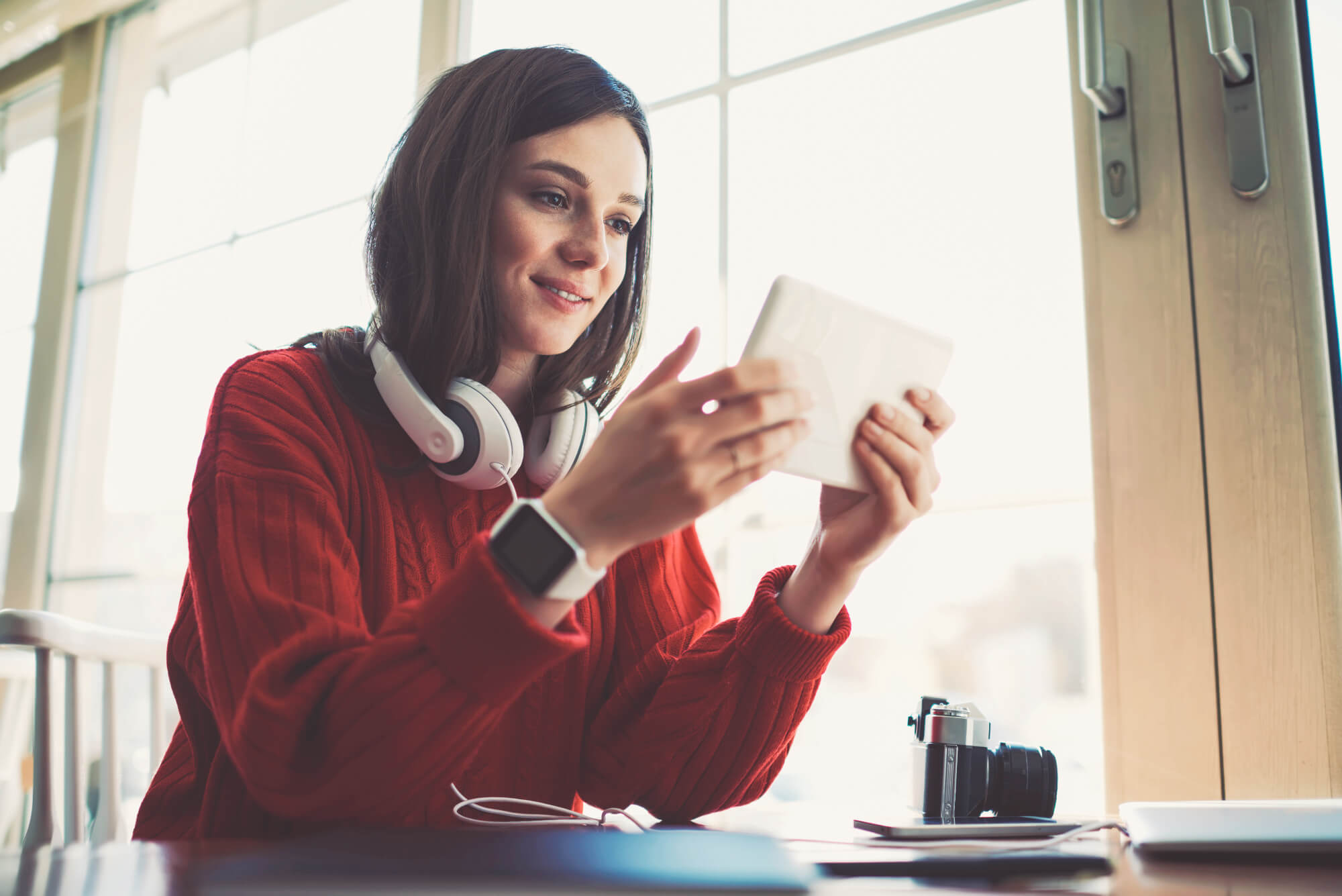 Woman with tablet and headphones